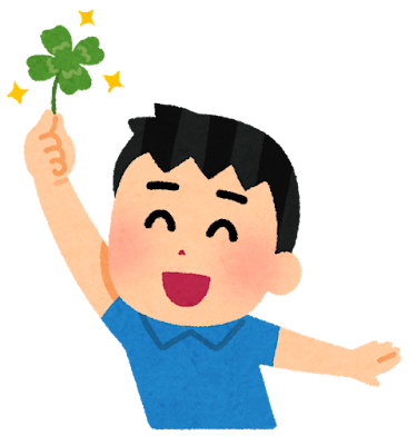 四葉のクローバーを見つける男の子